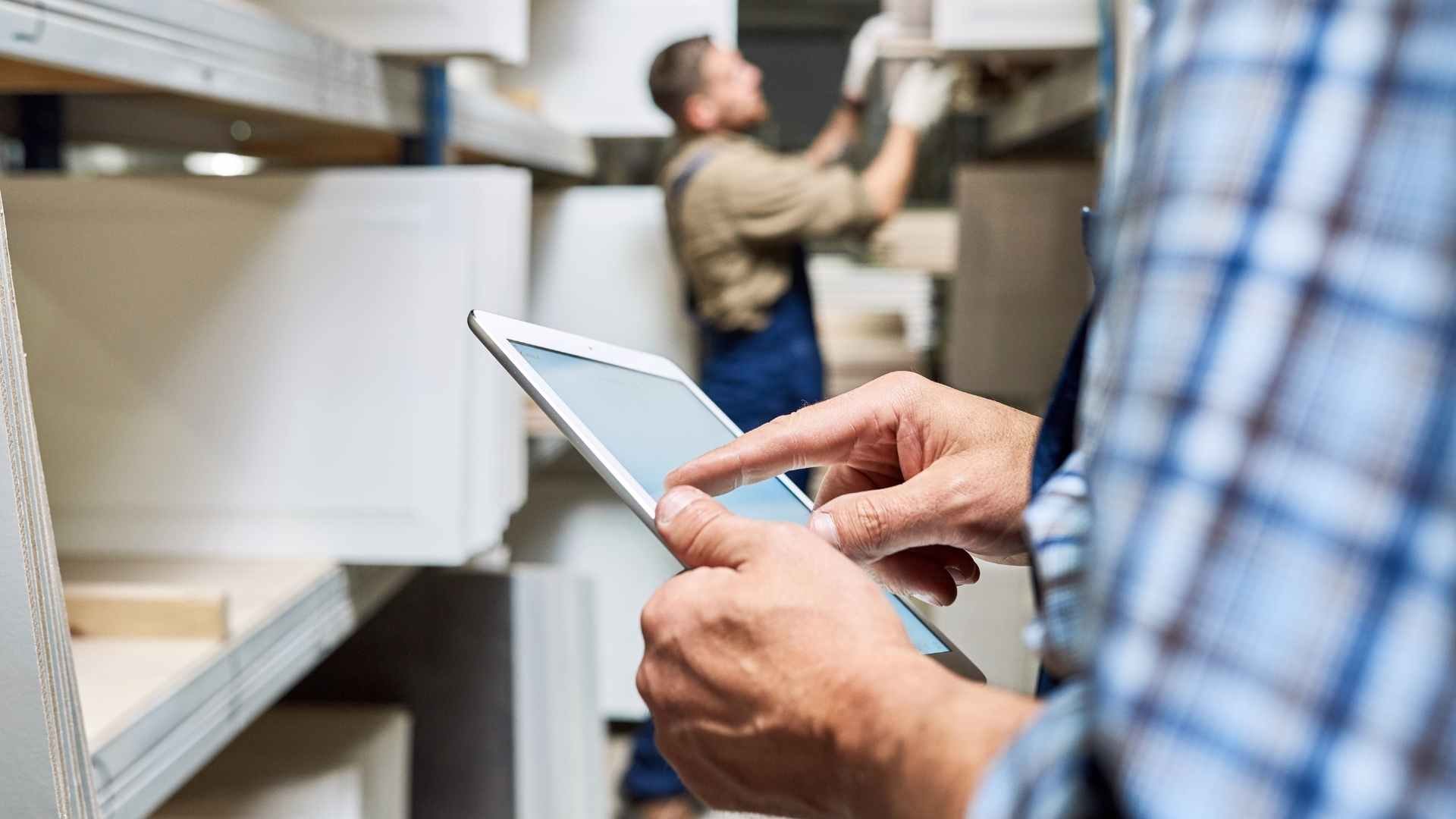 worker using digital tablet in warehouse